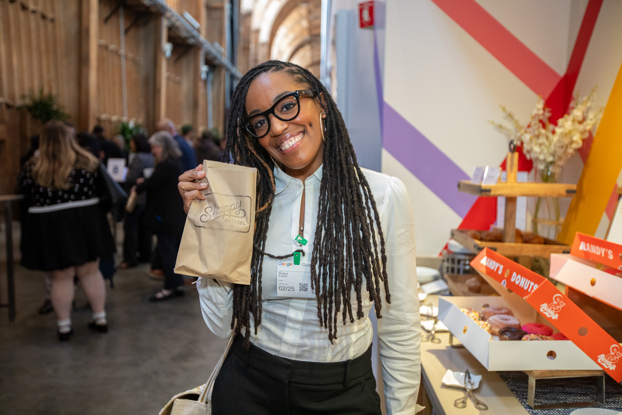 A small business owner smiling at a Hello Alice Main Street Rising event in Los Angeles