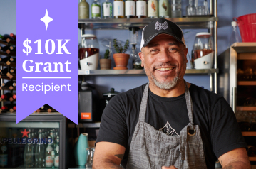 An image of a smiling african-america man in an apron with the text 25k Grant Recipient
