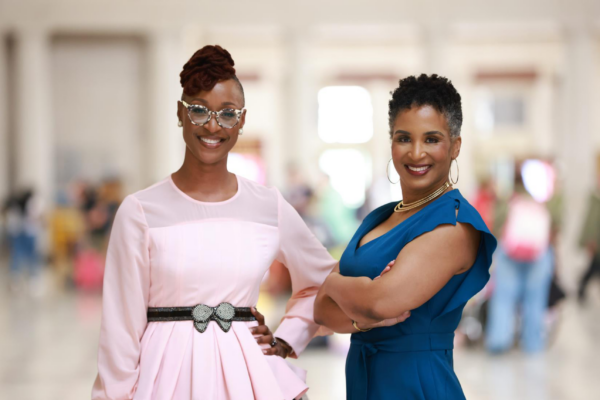 Two entrepreneurs pose side by side.