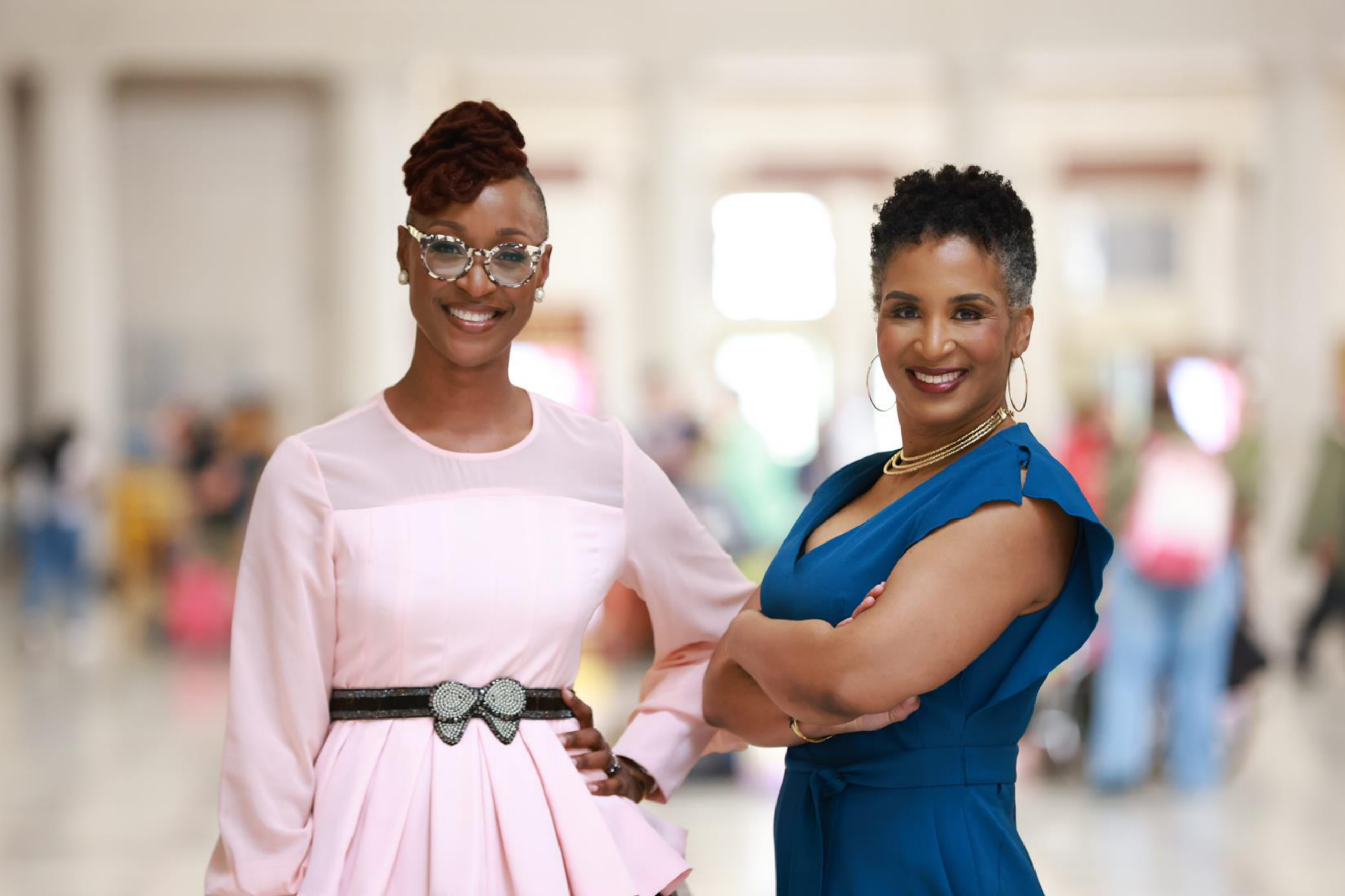Two entrepreneurs pose side by side.