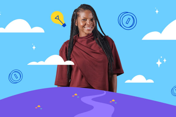 A Black female entrepreneur smiles proudly.