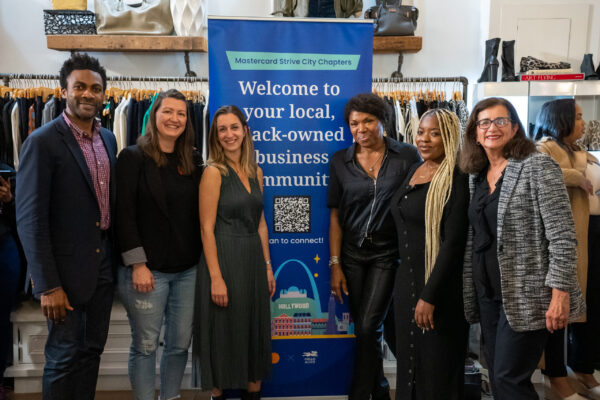 Black entrepreneurs and representatives of Hello Alice and Mastercard pose at an event for Black-owned small businesses.
