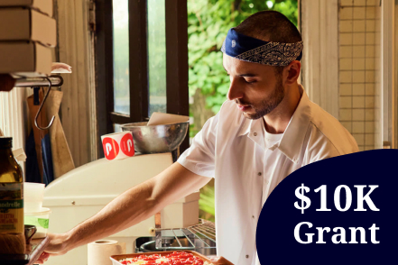 An image of a young man in a kitchen holding a baking pan with text saying $10K grant