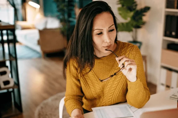 woman sitting at desk thinking