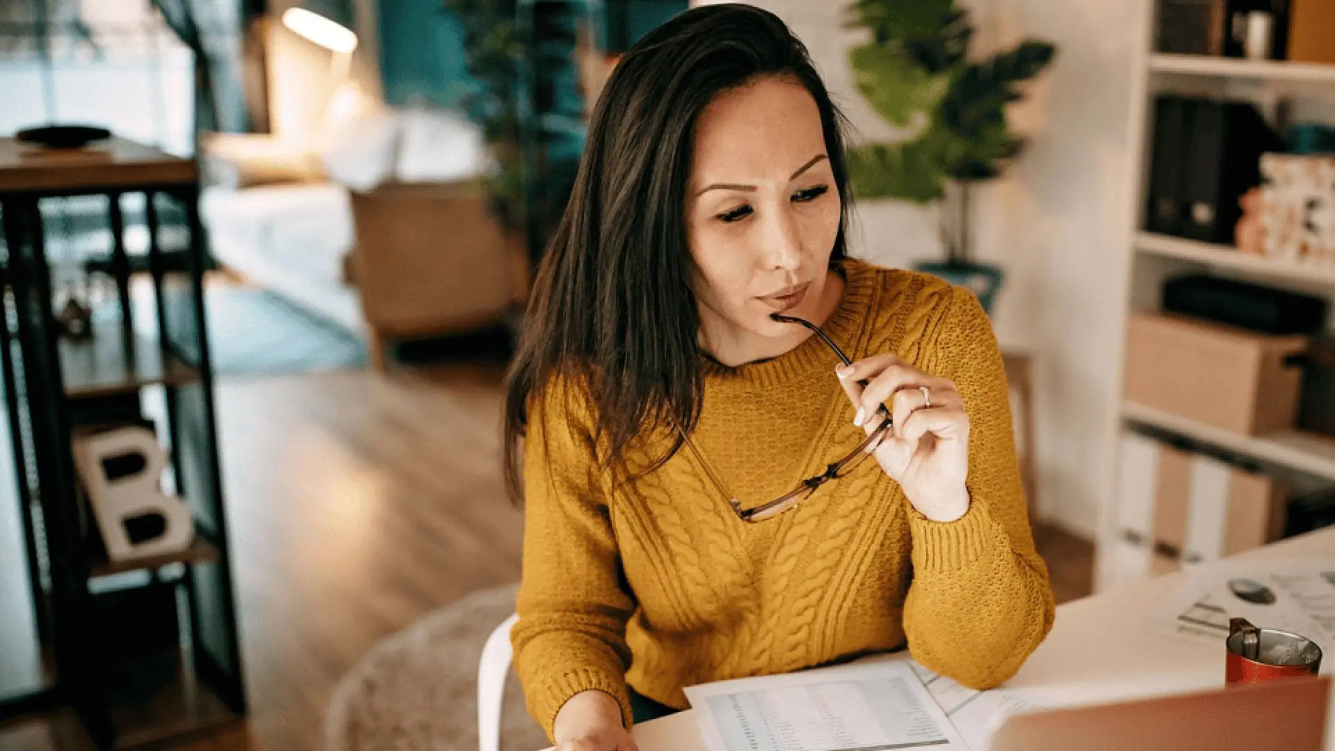 woman sitting at desk thinking